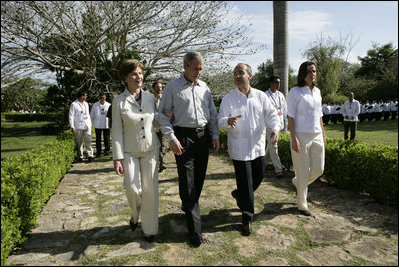President George W. Bush and Mrs. Laura Bush walk with Mexico's President Felipe Calderon and Mrs. Margarita Zavala upon their arrival Tuesday, March 13, 2007, to Hacienda Temozon in Temozon Sur, Mexico.