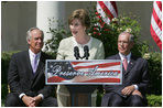 Mrs. Laura Bush is joined by U.S. Secretary of the Interior Dirk Kempthrone, left, and Jon Nau III, chairman of the Advisory Council on Historic Preservation, as she addreses guests in the White House Rose Garden, Wednesday, May 9, 2007, during the Preserve America President Awards ceremony.