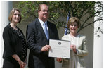 Mrs. Laura Bush poses with Mayor Wayne McCullen of Natchitoches, La., center, and Nancy Morgan, Cane River National Hertiage Area commission executive director, as she presents them with a 2007 Preserve America Presidential Award in the Rose Garden at the White House Wednesday, May 9, 2007, honored for their implementation of a comprehensive hertiage tourism plan for their region.