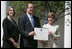 Mrs. Laura Bush poses with Mayor Wayne McCullen of Natchitoches, La., center, and Nancy Morgan, Cane River National Hertiage Area commission executive director, as she presents them with a 2007 Preserve America Presidential Award in the Rose Garden at the White House Wednesday, May 9, 2007, honored for their implementation of a comprehensive hertiage tourism plan for their region.