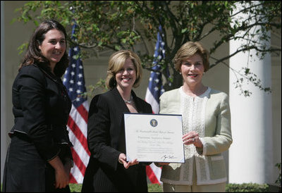 Mrs. Laura Bush presents a plaque to Abbe Raven, center, president and CEO of A&E Television Networks, and Nancy Dubuc, president of The History Channel, honoring them with a 2007 Preserve America Presidential Award in the Rose Garden at the White House Wednesday, May 9, 2007, honored for the establishment of the Save Our History grant program for historic preservation, and promotion of the historic hertiage of America.