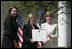 Mrs. Laura Bush presents a plaque to Abbe Raven, center, president and CEO of A&E Television Networks, and Nancy Dubuc, president of The History Channel, honoring them with a 2007 Preserve America Presidential Award in the Rose Garden at the White House Wednesday, May 9, 2007, honored for the establishment of the Save Our History grant program for historic preservation, and promotion of the historic hertiage of America.