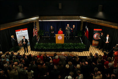 Mrs. Laura Bush delivers remarks during the announcement of the Jenna Welch Women's Center at Texas Tech - Permian Basin Campus Wednesday, Nov. 7, 2007, in Midland, Texas. Mrs. Bush is joined on stage by Speaker Tom Craddick of the Texas House of Representatives, left, Dr. John Jennings, center, and Texas Tech University Chancellor Kent Hance.