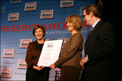 Mrs. Laura Bush presents fifth grade history teacher Maureen Festi, center, who teaches at Stafford Elementary School in Stafford, Conn., with the 2007 Preserve America National History Teacher of the Year Award at the Museum of the City of New York, Friday, Nov.16, 2007 in New York. Dr. James Basker, president of the Gilder Lehrman Institute for American History.