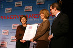 Mrs. Laura Bush presents fifth grade history teacher Maureen Festi, center, who teaches at Stafford Elementary School in Stafford, Conn., with the 2007 Preserve America National History Teacher of the Year Award at the Museum of the City of New York, Friday, Nov.16, 2007 in New York. Dr. James Basker, president of the Gilder Lehrman Institute for American History.