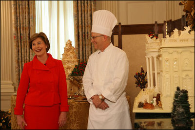 Laura Bush stands with White House Pastry Chef Bill Yosses during the press preview Thursday, Nov. 29, 2007, in the State Dining Room. They discussed the gingerbread White House. Based on a foundation of gingerbread, the structure consists of 300 pounds of white chocolate and gingerbread. 