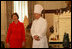 Laura Bush stands with White House Pastry Chef Bill Yosses during the press preview Thursday, Nov. 29, 2007, in the State Dining Room. They discussed the gingerbread White House. Based on a foundation of gingerbread, the structure consists of 300 pounds of white chocolate and gingerbread. 