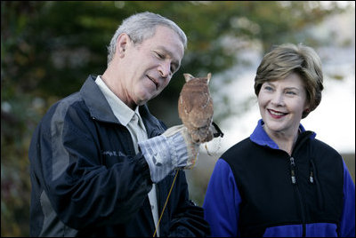 President George W. Bush and Mrs. Laura Bush have a close look at a screech owl Saturday, Oct. 20, 2007 at the Patuxent Research Refuge in Laurel, Md., where President Bush discussed steps his Administration is creating for a series of cooperative conservation steps to preserve and restore critical stopover habitat for migratory birds in the United States.