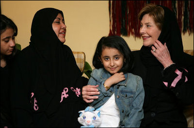 Mrs. Laura Bush talks with Dr. Samia Al-Amoudi, a breast cancer survivor, during a "Breaking the Silence" Coffee Wednesday, Oct. 24, 2007, in Jeddah, Saudi Arabia. Mrs. Bush met with breast cancer survivors and members of their families to discuss awareness issues. Pictured at left is Dr. Samia's daughter, Esraa Al-Harbi, 10-year-old author of a children's book entitled, "My Mother and Breast Cancer." The child at center is unidentified.