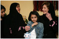 Mrs. Laura Bush talks with Dr. Samia Al-Amoudi, a breast cancer survivor, during a "Breaking the Silence" Coffee Wednesday, Oct. 24, 2007, in Jeddah, Saudi Arabia. Mrs. Bush met with breast cancer survivors and members of their families to discuss awareness issues. Pictured at left is Dr. Samia's daughter, Esraa Al-Harbi, 10-year-old author of a children's book entitled, "My Mother and Breast Cancer." The child at center is unidentified.