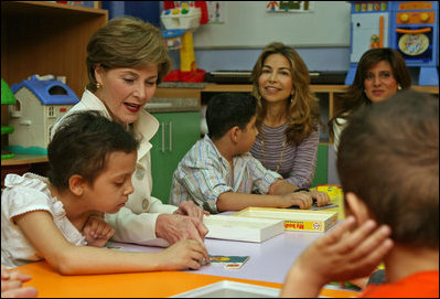 Mrs. Laura Bush helps Balkes Nafe put together a puzzle during a visit with young patients in the Children's Playroom at the King Hussein Cancer Center Thursday, Oct. 25, 2007, in Amman, Jordan. Also pictured are Her Royal Highness Princess Ghida Talal, left, and Her Royal Highness Princess Dina Mired bin Ra'ad.