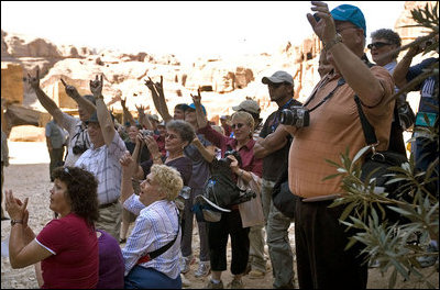 A group of tourists from Texas wave to Mrs. Laura Bush while touring Petra Friday, Oct. 26, 2007, in southern Jordan. Last year more than 300,000 visitors from around the world toured the ancient ruins.