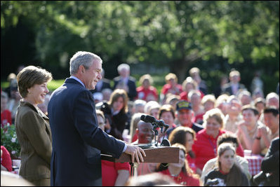Standing with Mrs. Laura Bush, President George W. Bush addresses military support organizations Tuesday, Sept. 18, 2007, on the South Lawn. "Laura and I welcome the families who have got a loved one overseas, whether it be in Iraq or Afghanistan, fighting these extremists and terrorists," said President Bush. "The best way to honor your loved one is to make sure that he or she has the full support of the United State s government as you accomplish the mission that we have set."