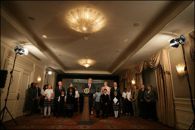 President George W. Bush discusses the reauthorization of No Child Left Behind Wednesday, Sept. 26, 2007, in New York. Those standing with President Bush include New York Mayor Michael Bloomberg, far left, Mrs. Laura Bush and students from New York Public School 76. "The No Child Left Behind Act is working. I say that because the Nation's Report Card says it's working," said President Bush. "Scores are improving, in some instances hitting all-time highs."