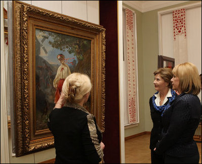 Mrs. Laura Bush and Mrs. Kateryna Yushchenko listen to Ms. Natalia Klimenko, General Director of the Taras Shevchenko National Museum, as she describes a painting by the great Ukrainian poet and artist during their tour Tuesday, April 1, 2008, in Kyiv.