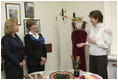 A volunteer briefs Mrs. Laura Bush and Mrs. Kateryna Yushchenko during their visit Tuesday, April 1, 2008, to the Ukraine Peace Corps headquarters in Kyiv. Mrs. Bush thanked all the volunteers for their service, telling them that during their 27 months of service, they serve as ambassadors for the United States, "sharing the best of our country with those who may never come into contact with another American."