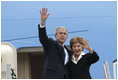 President George W. Bush and Mrs. Laura Bush wave upon their Romanian arrival Tuesday, April 1, 2008, at Henri Coanda International Airport in Bucharest, site of the 2008 NATO Summit.