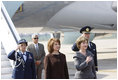 Mrs. Laura Bush holds her hand over her heart during the playing of the national anthem Wednesday, April 2, 2008, as she stands with Mrs. Maria Basescu, spouse of Romania's President Traian Basescu, on the red carpet during the arrival ceremony at Mihail Kogalniceanu Airport in Constanta, Romania. 