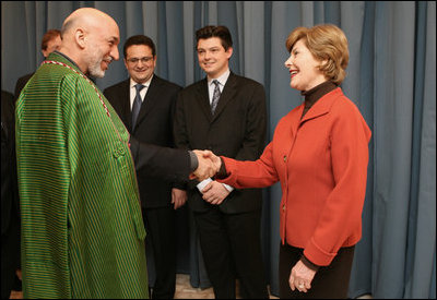 Mrs. Laura Bush greets Afghanistan President Hamid Karzai at the Headquarters of the Romanian Intelligence Service Thursday, April 3, 2008, where they participated in the Young Atlanticist Summit Video Conference with Kabul University.