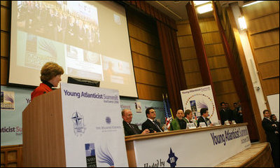 Mrs. Laura Bush acknowledges Afghanistan's President Hamid Karzai and his country's democratic successes during their appearance at the Bucharest headquarters of the Romanian Intelligence Service Thursday, April 3, 2008, for a video teleconference with students from Kabul University as part of the Young Atlanticist Summit.