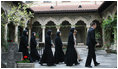 Mrs. Laura Bush and Sisters of the Stavropoleos Monastery in Bucharest, follow Dr. Petre Radu Guran as he leads them across the church courtyard Friday, April 4, 2008. In 2003, the U.S. Embassy donated $27,000 for the restoration of the courtyard under the auspices of a special U.S. Department of State program entitled, "Ambassador's Fund for Cultural Preservation."