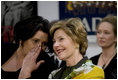Mrs. Laura Bush watches the Lado National Fold Dance Ensemble performance, Saturday, April 5, 2008 in Zagreb, as an interpreter translates the performance lyrics for her.