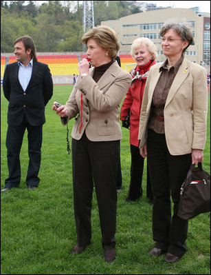 Mrs. Laura Bush blows a whistle to start the 100-meter wheelchair race Sunday, April 6, 2008, during her visit with the Russian Paralympic Team at Central Sochi Stadium in Sochi, Russia.