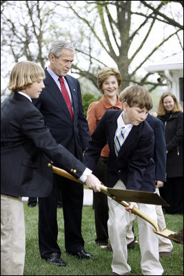 President George W. Bush and Mrs. Laura Bush watch kids shovel dirt to help plant a Scarlet Oak tree Wednesday, April 9, 2008, at the commemorative tree planting on the North Lawn of the White House. The Scarlet Oak replaces a tree planted by President Benjamin Harrison that fell on October, 25, 2007.
