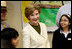 Mrs. Laura Bush joins students from the Williams Preparatory School in Dallas, Thursday, April 10, 2008, during a seed planting demonstration at the First Bloom program to help encourage youth to get involved with conserving America's National Parks. The First Bloom program is being introduced in five cities across the nation to give children a sense of pride in our natural resources and to be good stewarts of America's diverse environment.