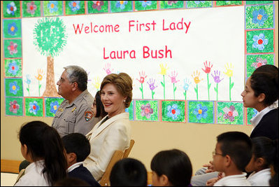 Mrs. Laura Bush sits before a banner welcoming her to the Williams Preparatory School in Dallas, Thursday, April 10, 2008, where she participated in the First Bloom program activities to help encourage youth to get involved with conserving America's National Parks. The First Bloom program is being introduced in five cities across the nation to give children a sense of pride in our natural resources and to be good stewarts of America's diverse environment.
