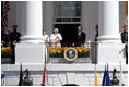 President George W. Bush and Mrs. Laura Bush stand with Pope Benedict XVI as he acknowledges the cheers from the crowd from the South Portico balcony Wednesday, April 16, 2008, on the South Lawn of the White House. 