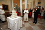 President George W. Bush and Mrs. Laura Bush lead the celebration of the 81st birthday of Pope Benedict XVI as he's presented a cake by White House Pastry Chef Bill Yosses Wednesday, April 16, 2008, at the White House.
