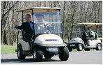 President George W. Bush waves as South Korean President Lee Myung-bak drives their golf cart, followed by Laura Bush and South Korea first lady Kim Yoon-ok in theirs Friday, April 18, 2008, at the Presidential retreat at Camp David, Md.