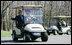 President George W. Bush waves as South Korean President Lee Myung-bak drives their golf cart, followed by Laura Bush and South Korea first lady Kim Yoon-ok in theirs Friday, April 18, 2008, at the Presidential retreat at Camp David, Md.