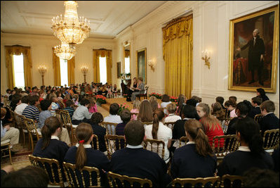 Mrs. Laura Bush and daughter, Jenna Bush, read a book to children of White House staff at Bring Your Child to Work Day Thursday, April 24, 2008, in the East Room of the White House.