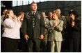 Mrs. Laura Bush joins the applause for Sgt. Gregory Williams after he was recognized by President George W. Bush Monday, Aug. 4, 2008, during remarks to military personnel at Eielson Air Force Base, Alaska.