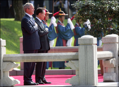 President George W. Bush and President Myung-bak Lee of the Republic of Korea, pause for their respective national anthems Wednesday, Aug. 6, 2008, during arrival ceremonies for President Bush and Mrs. Laura Bush in Seoul.