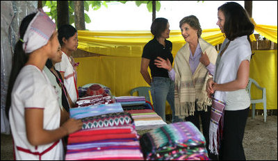 Mrs. Laura Bush and daughter Ms. Barbara Bush look over the weaving done by refugee women at the Mae La Refugee Camp at Mae Sot, Thailand, on Aug. 7, 2008. This traditional Karen craft helps the refugees make money and can be bought via the Internet through consortiums that work with the women in the camp which houses at least 39,000 Burmese.