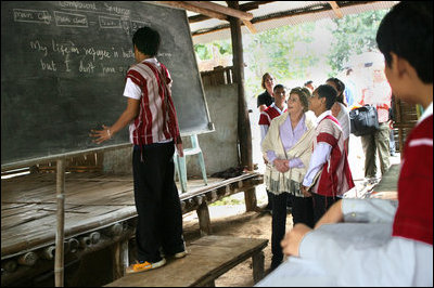 Mrs. Laura Bush watches as an English student works at the chalkboard of a grammar class at the Mae La Refugee Camp in Mae Sot, Thailand, on Aug. 7, 2008. The English lesson on the chalkboard uses the sentence to discuss compound sentence structure: "My life in refugee is better than Burma but I don't have opportunity to go outside of my camp. The visit to the camp in Mae Sot, Thailand, highlighted the fact that it has been 20 years since the crackdown in Burma that sent many people fleeing the dire conditions. Many residents have been born in one of the nine camps along the border or have lived most of their lives there.