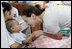 Ms. Barbara Bush, daughter of President George W. Bush and Mrs. Laura Bush, spends a playful moment with a small child during her visit to the Mae Tao Clinic at the Mae La Refugee Camp in Mae Sot, Thailand Thursday, Aug. 7, 2008. 