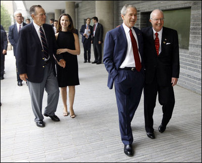 President George W. Bush is greeted by U.S. Ambassador Sandy Randt upon his arrival Friday, Aug. 8, 2008, at the U.S. Embassy in Beijing. With them are former President George H.W. Bush and Ms. Barbara Bush.