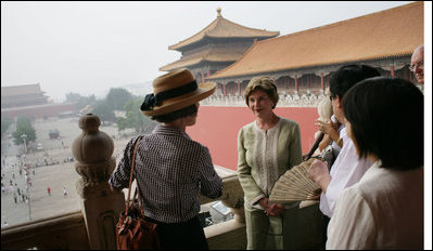 Mrs. Laura Bush listens as Mrs. Sarah Randt, spouse of the U.S. Ambassador to the People's Republic of China, leads a tour of the Forbidden City Friday, Aug. 9, 2008, in Beijing.