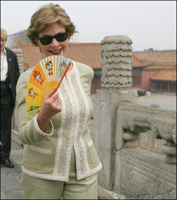Mrs. Laura Bush finds relief from the Beijing heat in an ornamental fan during a visit Friday, Aug. 9, 2008, to the Forbidden City.