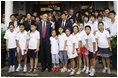 President George W. Bush and Mrs. Laura Bush stand outside the Kuanjie Protestant Christian Church with members of the Kuanjie Summer Vacation School Choir after attending services Sunday, Aug. 10, 2008, in Beijing.