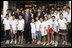 President George W. Bush and Mrs. Laura Bush stand outside the Kuanjie Protestant Christian Church with members of the Kuanjie Summer Vacation School Choir after attending services Sunday, Aug. 10, 2008, in Beijing.