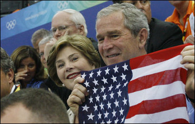 President George W. Bush and Mrs. Laura Bush cheer on the U.S. Olympic swimmers during the Sunday morning competition at the National Aquatics Center in Beijing.
