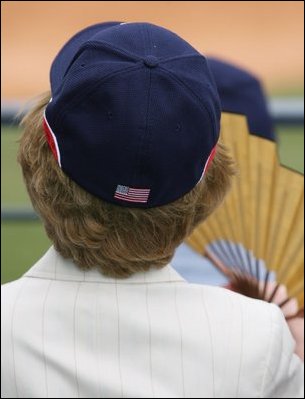 Mrs. Laura Bush wearing a U.S. Olympic baseball team hat watches the U.S. Olympic men's baseball team play a practice game against the Chinese Olympic men's baseball team Monday, Aug. 11, 2008, at the 2008 Summer Olympic Games in Beijing.