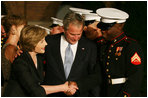 Laura Bush greets participants of the Evening Parade at the Marine Barracks in Washington, D.C., as President George W. Bush looks down at the official barracks mascot, Chesty Friday, August 29, 2008, in Washington D.C. 