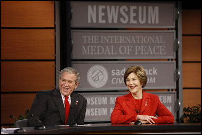 President George W. Bush and Mrs. Laura Bush react during a question and answer session Monday, Dec. 1, 2008, at the Saddleback Civil Forum on Global Health at the Newseum in Washington, D.C.
