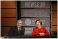President George W. Bush and Mrs. Laura Bush react during a question and answer session Monday, Dec. 1, 2008, at the Saddleback Civil Forum on Global Health at the Newseum in Washington, D.C.